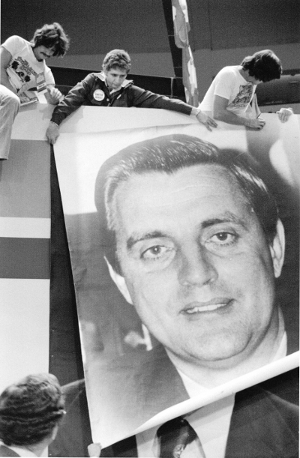 Campaign poster of Walter Mondale being put up 