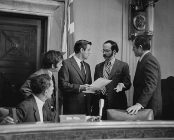Senator Walter Mondale, Senator Ted Kennedy, and unidentified aide conferring during Congressional hearing