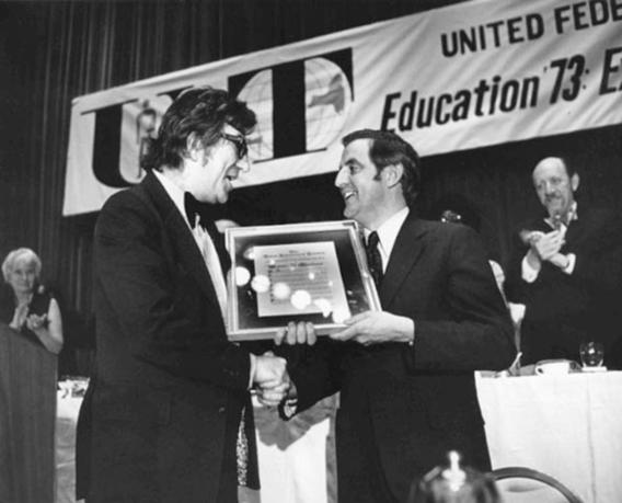 Albert Shanker, president of the United Federation of Teachers (UFT), shaking hands and presenting framed award to Senator Walter Mondale 