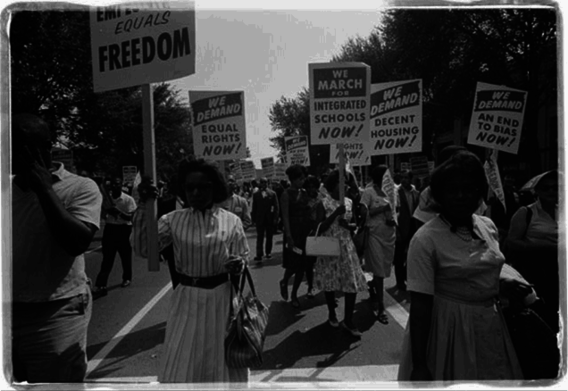 Civil rights march on Washington, D.C., 1963. One sign says: "We demand an end to bias now."