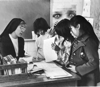 Sister Louise wearing a nun habit and her students at St. Mary's Mission School, Red Lake Nation