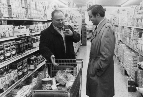Senator Walter Mondale shops in a grocery store with a constituent