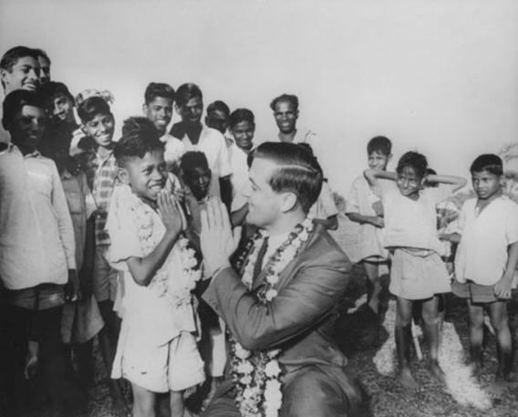 Senator Mondale exchanges the Namaste greeting with a boy in India as other children look on