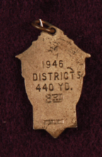 Back of 440 yard relay medal. "1946 District 5 440 Yd." etched on back.